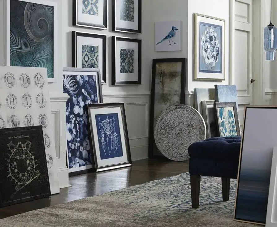 Various framed artwork displayed in a stylish room.
